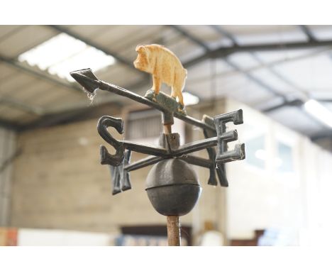 A painted metal pig weather vane on associated stand, height 76cm