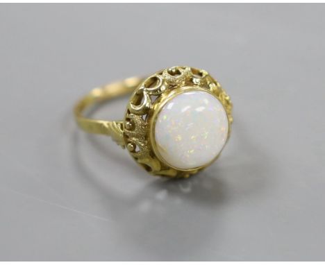 A 750 yellow metal and cabochon white opal set ring, with pierced setting, size U/V, gross weight 5 grams.