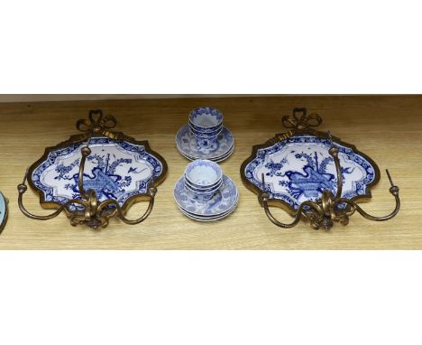 A pair of 19th century ormolu blue and white Delft wall sconces and with blue and white Chinese tea bowls and saucers forming