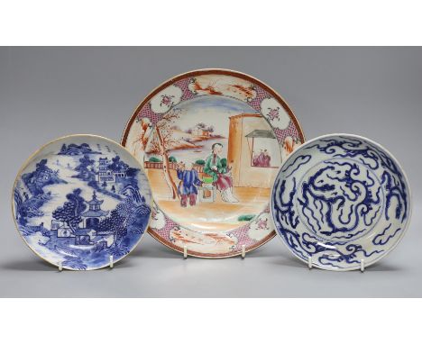 An 18th century Chinese export famille rose plate and two similar blue and white saucers, largest 23cm