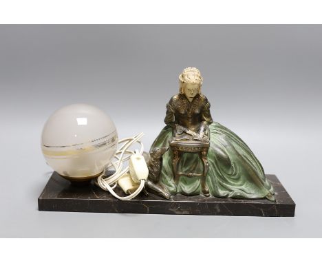 A French 1930's lamp with a seated female reading beside a laying loyal hound on marble plinth base, signed R. Miandres, 32cm