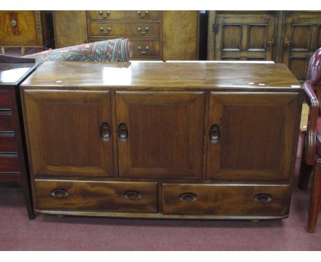 Ercol Sideboard, with oval handles to three cupboard doors and two lower drawers, on Shepherds castors, 129.5cm wide.