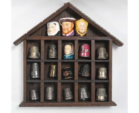 Thimbles - two silver, twelve in metal, four in ceramic, with rack.