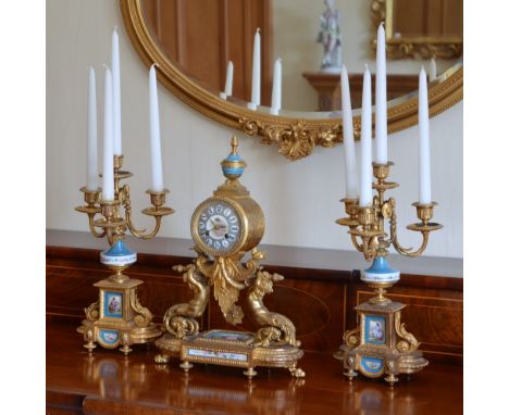 A late 19th century French ormolu and porcelain mounted clock garniture, the mantel clock with circular dial and Roman numera