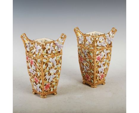 A pair of Zsolnay Pecs reticulated twin handled square form vases, the tapered bodies decorated with flowers and foliage, rai