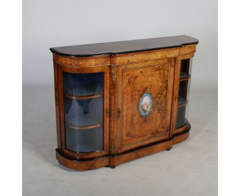 A Victorian walnut, gilt metal and porcelain mounted credenza, the shaped rectangular top above a rectangular panelled door d