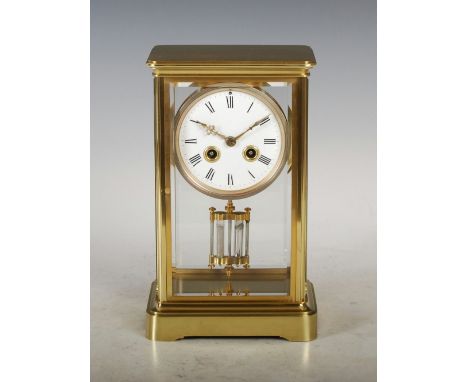 A late 19th/ early 20th century lacquered brass mantle clock, the circular enamel dial with Roman numerals and twin train mov