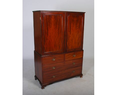 A George III mahogany linen press, the moulded cornice above a pair of panelled cupboard doors opening to a fitted interior o