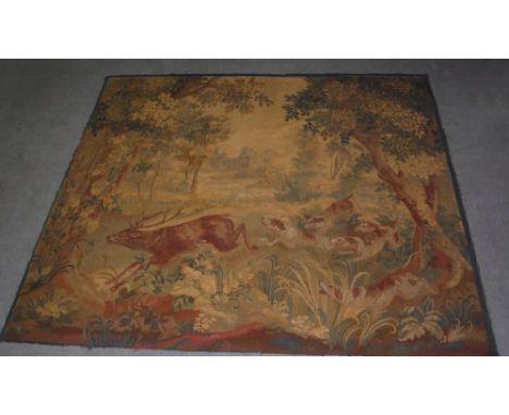 An early 20th century Aubusson style tapestry wall hanging, worked in ochre, brown and green coloured threads to depict a sta
