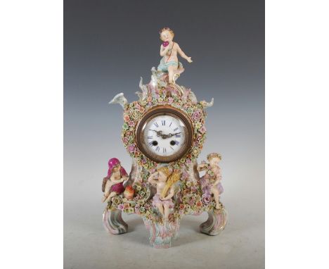 A late 19th century French porcelain mantle clock, the circular enamel dial with Arabic and Roman numerals and twin train mov