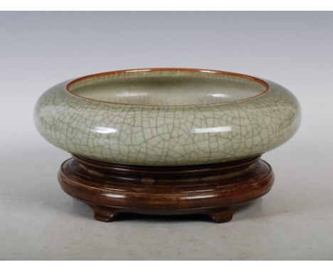 A Chinese porcelain crackle-glazed celadon ground bowl, late Qing Dynasty, of shallow circular form, with incised four charac