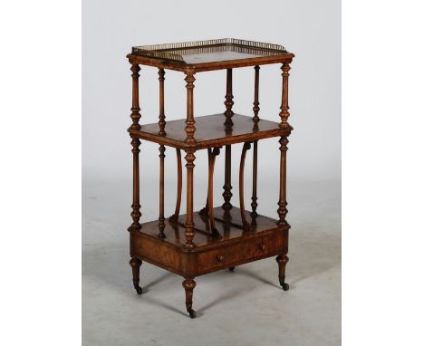 A Victorian walnut whatnot, the rectangular top with pierced gilt metal three quarter gallery, raised on fluted tapered cylin