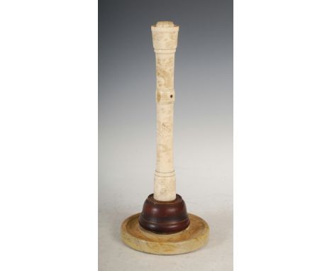 A Chinese bone wig stand, Qing Dynasty, carved with dragons and foliage on a painted turned wood base, 33cm high