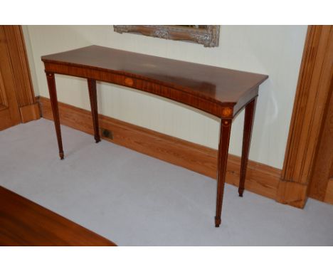 A 19th century mahogany and boxwood lined inverted bow front console table, the shaped rectangular top centred with oval inla