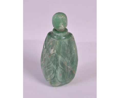 A late 19th/ early 20th century Indian jade scent bottle and stopper, the oval-shaped bottle carved with serrated leaves, 8.5