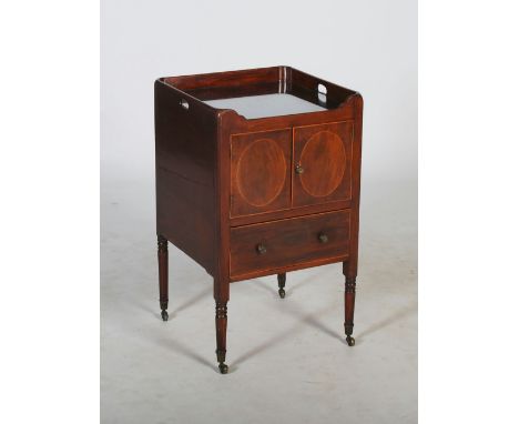 A 19th century mahogany and boxwood lined tray top commode, the pierced three quarter gallery above a pair of cupboard doors 