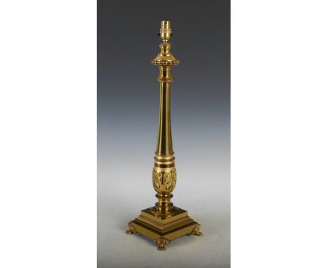 A late 19th century gilt metal table lamp, the baluster shaped column with acanthus cast collar, raised on a stepped square p