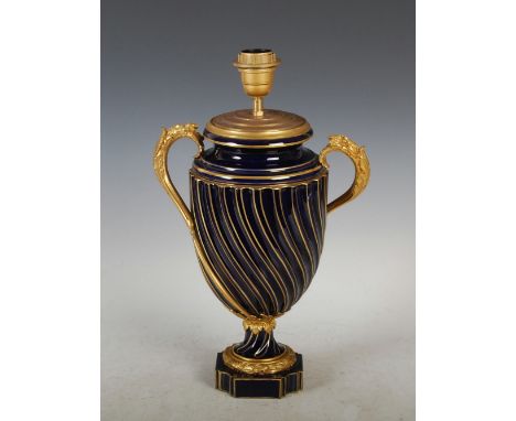 A French porcelain cobalt blue ground ormolu mounted twin handled urn formed as a table lamp, possibly Sevres, of spiral flut