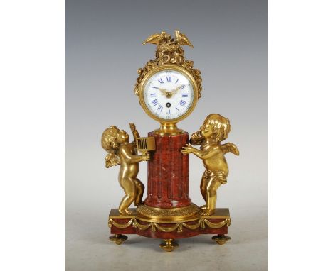 A late 19th/ early 20th century ormolu and marble mantle clock, the circular enamel dial with Arabic and Roman numerals suppo