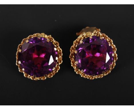 A pair of amethyst earrings, with yellow metal rope twist borders and clip fixings, 1.5cm diameter