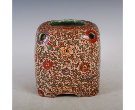 A Japanese pottery jar/ jardiniere, of rectangular form with a circular rim and six smaller circular holes, decorated with fl