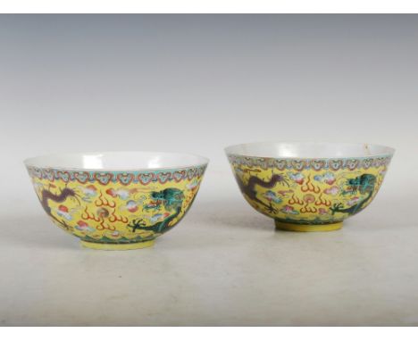 A pair of Chinese porcelain yellow ground dragon bowls, six character Kangxi marks but later, decorated with green and auberg