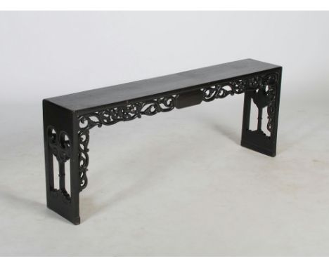 A Chinese dark wood bench, late 19th/ early 20th century, the plain rectangular seat above a fruit and foliate carved frieze 