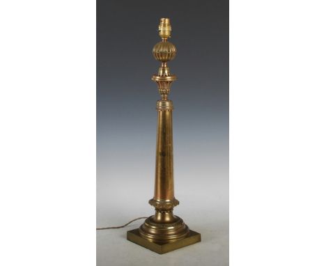 A late 19th century gilt metal table lamp, the light fitting supported on a tapered cylindrical column with foliate cast coll