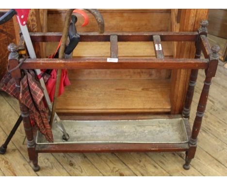 An Edwardian mahogany stick stand with drip tray