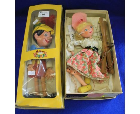 Pelham puppets: Pinocchio figure in box, together with another puppet of girl. (2)