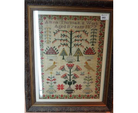 Framed tapestry sampler, 'Anne Thomas's work, aged 11 years, 1877'.  Framed and glazed.