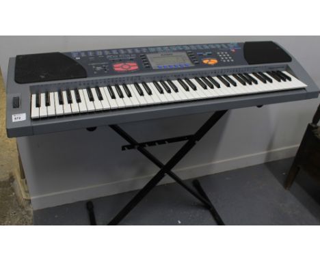 Casio WK-1200 electric keyboard on stand.
