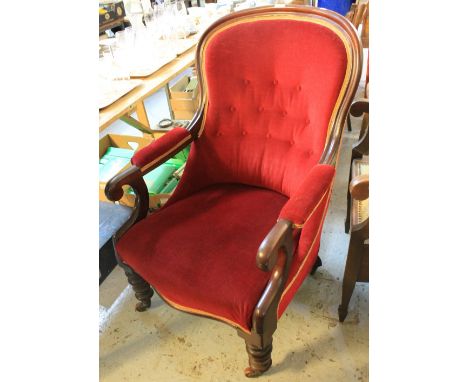 Victorian mahogany button back, upholstered, fireside chair on ring turned legs and casters. CONDITION REPORT: Nice old chair