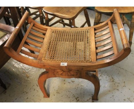 Modern hardwood concave, cane seated stool. CONDITION REPORT: Sound and good condition.