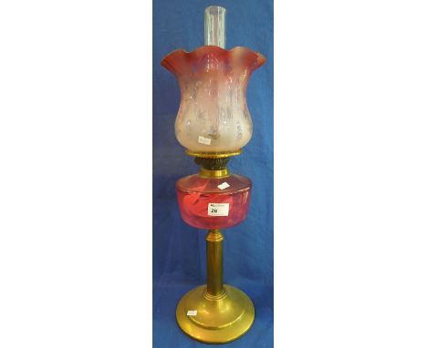 Brass double burner oil lamp with cranberry glass reservoir and brass pedestal base, etched foliate glass shade and clear chi