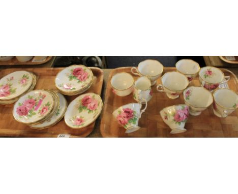 Two trays of Royal Albert bone china 'American Beauty' teaware comprising: teacups and saucers; milk jug; sucrier and side pl