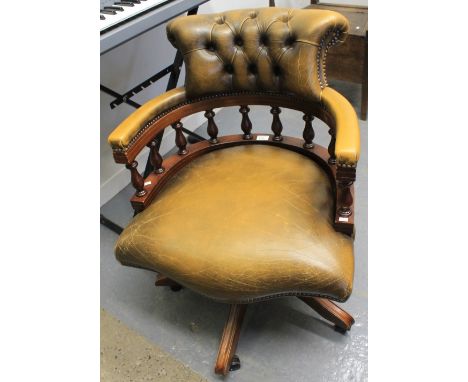 Reproduction leather button back swivel captain's or office chair. CONDITION REPORT: Some minor marks/wear in places but over