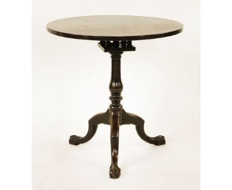 A George III mahogany circular tripod table,the solid top over a birdcage, over a turned column on claw and ball feet, 69cm d