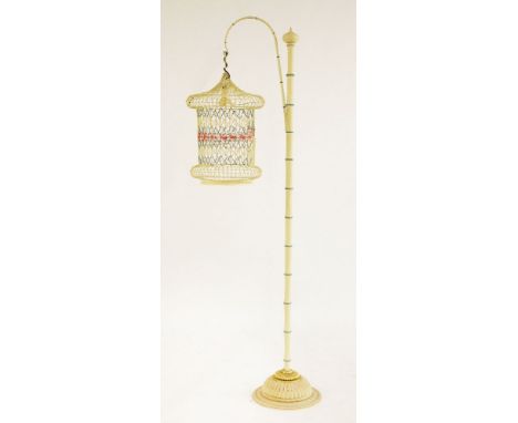 A standard lamp in the form of a birdcage,20th century, the painted wirework 'shade' on a painted metal imitation bamboo stan