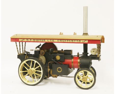 A Markie Models Showman's Steam Engine, 1/10th scale, finished in black and red with brass fittings, with cream spoked road w