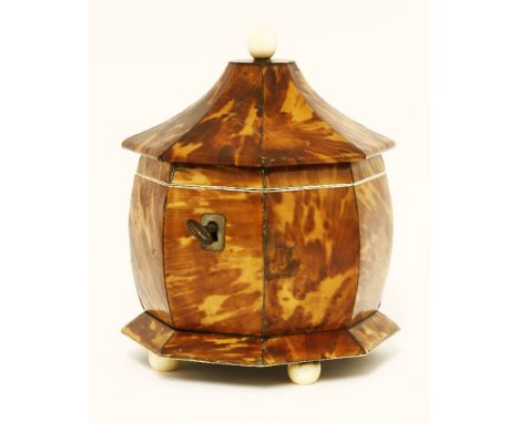 An octagonal blonde tortoiseshell twin compartment tea caddy, with pewter stringing and on ivory knob, feet and mounts,19cm h