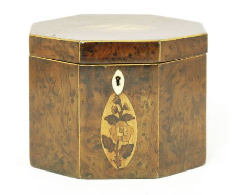 A George III yew wood inlaid octagonal tea caddy, with boxwood stringing the front inlaid with a flower, the top a shell, wit