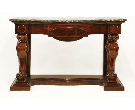 A Victorian mahogany console table, the marble top over a central drawer on heavy carved scroll supports, united with a plint