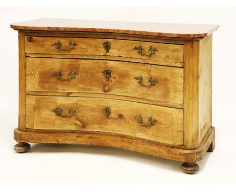 A French pine commode, 19th century, the inverted serpentine front with three long drawers below a rouge marble top, 113cm wi