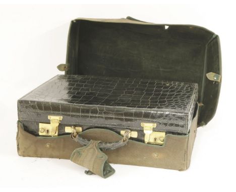 A crocodile skin dressing case,by Finnigans, 18 New Bond St. London, the fitted interior with three silver-mounted brushes, s