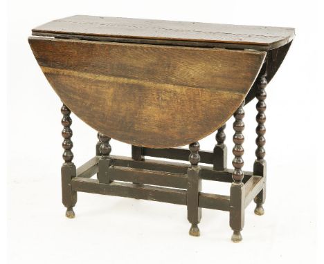 An oak drop-leaf table,basically 17th century, on bobbin turned supports and square stretchers,91cm wide73cm high