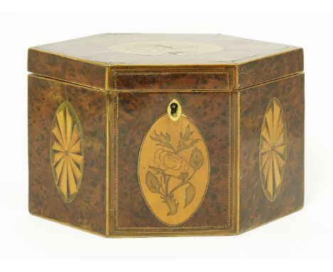 A George III hexagonal yew wood inlaid tea caddy, with floral and fan panels, boxwood and chequer strung, with two compartmen