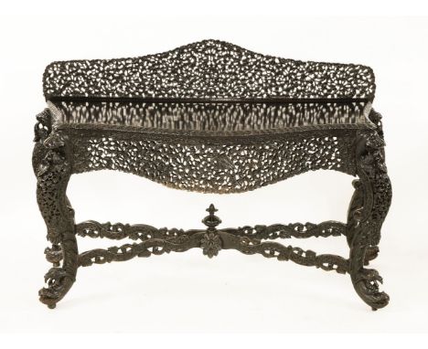 An Anglo-Indian rosewood and stained console table,the serpentine front over carved legs, with a shaped back, united with an 