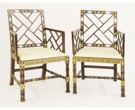 A pair of mahogany elbow chairs,20th century, in the Chinese Chippendale style, parcel gilt, with cluster column front legs, 
