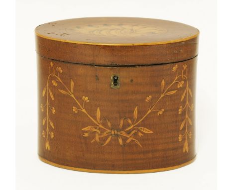 A George III oval mahogany tea caddy, the front inlaid with a ribbon and swag, the top with a shell, 14.5cm wide 8.5cm deep 1